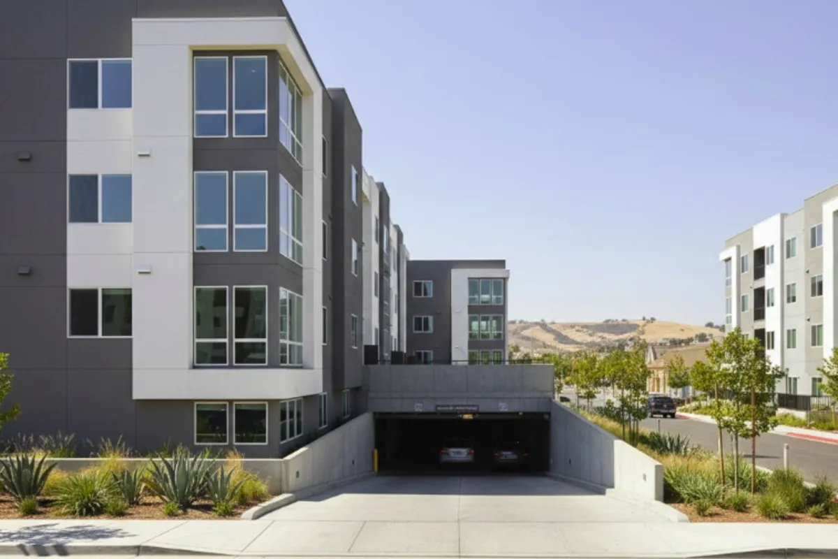 Podium-style apartment building with below-grade parking vulnerable to flood exposure